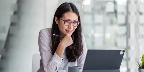 Woman wearing glasses using a computer