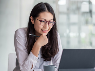 Woman wearing glasses using a computer